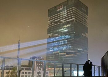 The Wrong Amazon Is Burning Projected On The Amazon Tower in Berlin